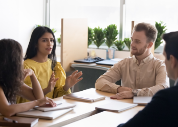 College students having a discussion at a meeting table